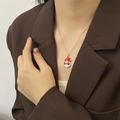 Gouden kerstketting met kerstman hanger in rood emaille gedragen door een model - Kerstman Halsketting / Goud
