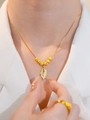 Close-up of gold leaf pendant necklace with crystals and matching ring on model - Six Lucky Beads Leaf (Box Chain) / Gold