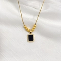 Detail of a gold rectangle pendant with black inlay and sparkling zircon border - Gold Black Card Style (6 Blessing Beads)