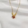 Macro view of golden maple leaf pendant with red gemstones and six matte beads - Gold Red Maple Leaf Style (6 Blessing Beads)