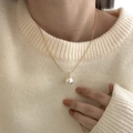 Minimalist gold necklace with a large round white pearl pendant on a beige sweater - Gold-White Pearl