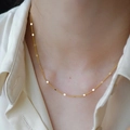 Elegant gold-plated chain necklace with small circular charms on a female model - Gold 38+5cm Flattened Chain