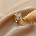 Golden clover rotating ring with pavé crystals on elegant silk background - Rotating Clover Flower (Gold)