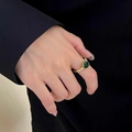 Square emerald cut green zircon ring in gold finish on model wearing a black blazer - Emerald Ring (Adjustable)