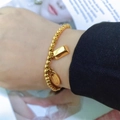 Gold beaded stretch bracelet with gold bar and lucky charm pendants in titanium steel - Gold - Fortune Charm