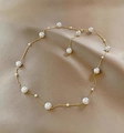 Detail van de parelketting op een champagne satijnen achtergrond met gouden ketting - Y-ketting / Goud