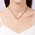 Detail of a gold-plated number 7 oval pendant on a black minimalist woven cord - Gold - Lucky 7 Black Cord