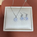 Silver sunflower jewelry set with sparkling crystals on a premium textured background - Sunflower Necklace And Earrings / Silver