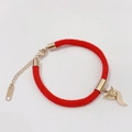 Red woven rope bracelet with gold fox pendant and lobster clasp on white background - Rose Gold Red Fox Bracelet