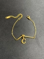 Macro shot of gold stainless steel knot bracelet with letter C pendant and S.steel hallmark - Letter C