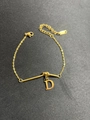 Detail of gold letter D pendant on stainless steel chain with lobster clasp - Letter D