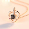 Rose gold heart projection necklace with Roman numerals and pink gemstone accent - Rose Gold