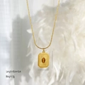 Macro view of vintage tiger eye stone necklace pendant with engraved sunburst texture - Rectangular Sunburst Style