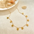 Golden bear charm necklace with lobster clasp and adjustable chain on a beach background - Bear Necklace / Gold