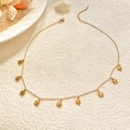 Detailed view of gold plated clover station necklace with delicate chain and lobster clasp - Heart Clover Necklace / Gold