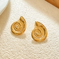 Detailed shot of golden conch earrings with sparkling zircons on a textured background - Gold Conch Stud Earrings With Zirconia