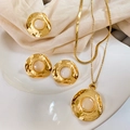 Macro shot of French retro jewelry set with hammered gold texture and moonstone details - French Vintage Hammered Set (A527)