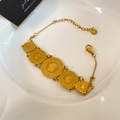 Macro detail of gold stainless steel bracelet with five embossed portrait coins and clasp - Gold Portrait Varied Size Five Round Coin Style (YMX1688-3)