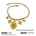 Detailed shot of a gold-plated snake chain bracelet with green stones and charms - Green Cabochon Heart Pendant Style (X1160)