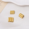 Macro view of gold-plated magnetic cylinder beads with engraved texture for DIY jewelry - 4*10mm / 18K Gold