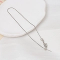 Macro shot of silver box chain with adjustable pin and lobster clasp for DIY jewelry - White K