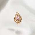 Detailed view of a vintage pink pear-shaped zircon pendant with gold plated finish - Pink