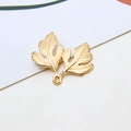 Macro shot of golden gingko leaf jewelry charms with realistic vein textures for DIY crafting - Style 01