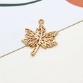 Detailed macro view of a golden hollow maple leaf pendant with DIY assembly loop - Style 03