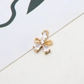 Macro shot of gold-plated copper flower pendant with white cubic zirconia and hanging loop - Small Flower Style (03#)
