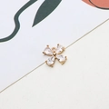Close-up of a gold four-leaf flower pendant with zircon stones for DIY jewelry making - Cross Flower Style (04#)