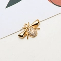 Macro shot of gold-plated bee pendant with white zircon stones for jewelry making - Bee Shape