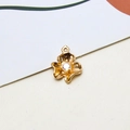 Macro detail of golden flower pendant with matte texture and sparkling center zircon - Three-Petal Flower Style (10#)