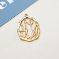 Detailed macro view of a golden bamboo branch pendant with hollow oval design for DIY jewelry - Oval Hollow Bamboo Node Pendant (06#)