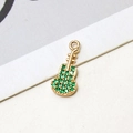 Macro detail of gold-plated guitar pendant with micro-paved green zircons and ring loop - Green Guitar Style