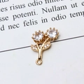 Macro detail of gold flower pendant with zircons and ring connector on book page - Flower Shape / 01# White