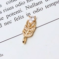 Macro detail of a golden feather pendant with shimmering pavé cubic zirconia inlay - 02#White