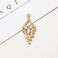 Detail macro of zircon encrusted copper pendant with elegant tassel and gold plating - 10 Pieces / No.01