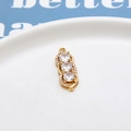 Macro shot of a gold triple zircon pendant with elegant sparkling spiral accents - No.02