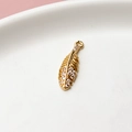 Macro view of gold-plated feather pendant with sparkling zircons and detailed textures - Standard Price / Leaf