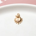 Macro shot of gold-plated micro-pave zircon bow pendant for DIY jewelry making - Standard Price / Sun Relief