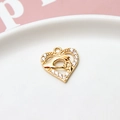 Macro shot of gold-plated heart pendant with zircon inlay showing two hands touching - Parent-Child Hand in Hand Heart Style / Gold