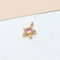 Macro shot of gold-plated star pendant with pink zircon crystals for DIY jewelry making - Star Pink