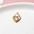 Macro shot of gold-plated hollow heart crown pendant with sparkling zircon gemstone inlay - Heart Crown Style / Gold