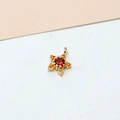 Macro detail of a 18K gold plated star pendant with orange zircon inlay for jewelry making - Star Orange