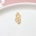 Macro shot of gold-plated hollow heart pendant with zircons on a white ceramic plate - Butterfly Clover Style / Gold