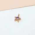 Macro view of gold-plated star pendant with inset purple zircon stones for DIY jewelry - Star Violet