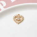 Macro shot of gold-plated heart pendant with zircon floral center for DIY jewelry - Heart Flower Cluster Style / Gold