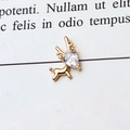 Macro shot of a gold-plated deer pendant featuring a pear-cut white zircon stone - Little Deer White