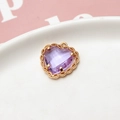 Detailed macro view of heart-shaped purple zircon pendant with gold-plated lace border - Light Purple