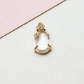 Detail of a crystal teardrop pendant with golden plum blossom accents and metal frame - 8*17MM / Clear White